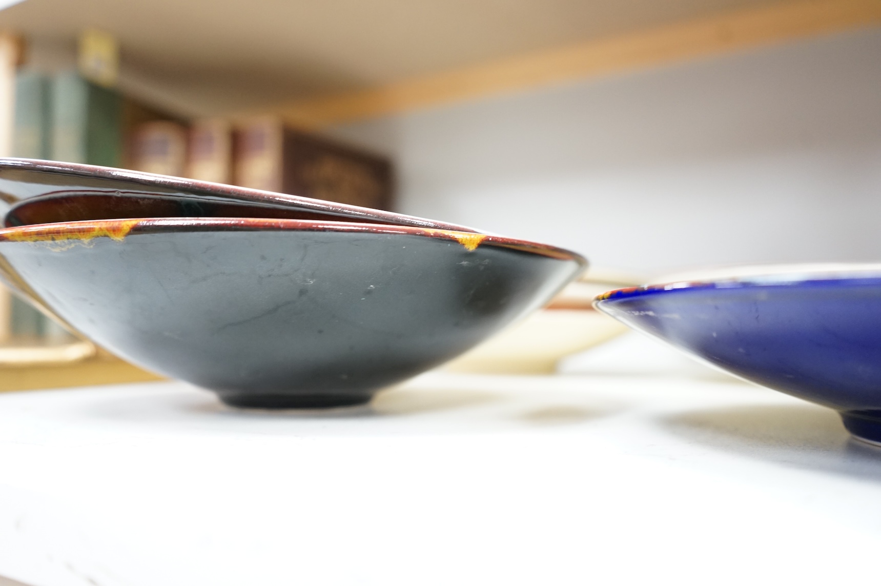 A Poole pottery ‘Gemstones’ fruit bowl and set of five smaller matching dishes, a similar patterned dish and two ‘Wild Poppy’ dishes. Fruit bowl 34cm diameter.
